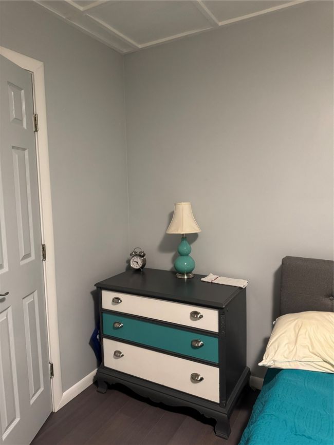 Bedroom with dark wood finished floors and baseboards | Image 19