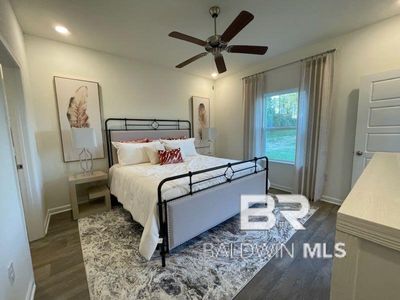 Bedroom featuring ceiling fan and dark hardwood / wood-style flooring | Image 2