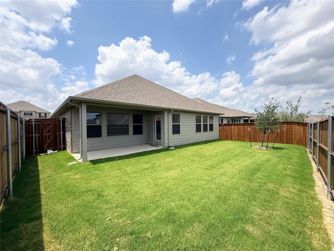 Rear view of property with a shingled roof and a patio | Image 36