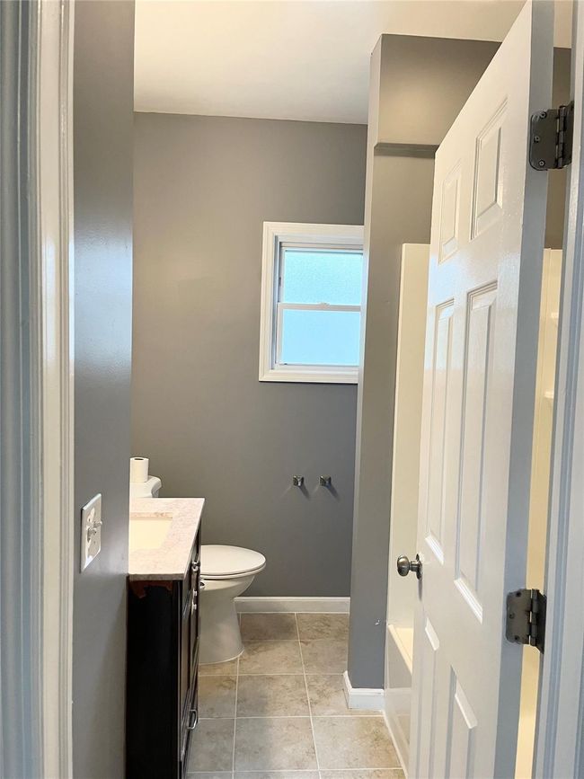 Unfurnished bedroom featuring wood finished floors, a closet, ceiling fan, and baseboards | Image 15