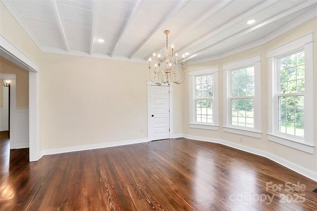 Look at those wood ceilings and beams featured in the dining room and kitchen! | Image 16