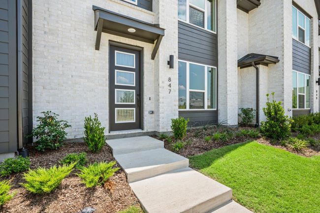 Featuring light brick with striking trim, this contemporary home offers fantastic curb appeal! | Image 4