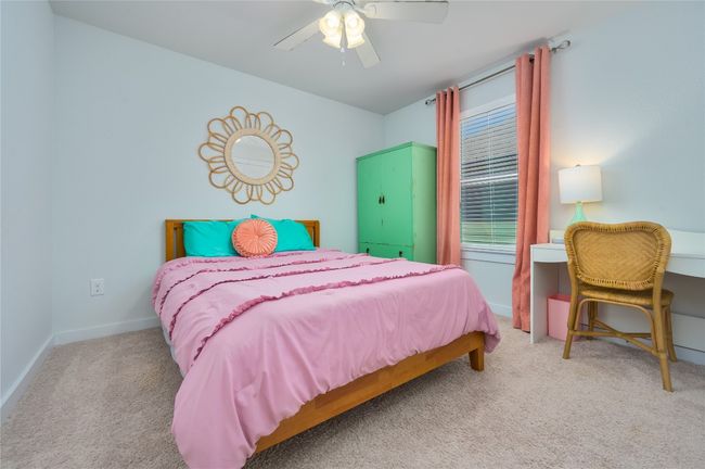 Bedroom with carpet flooring, a ceiling fan, and multiple windows | Image 16