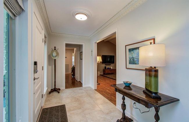 Greet your guests in this spacious foyer framed with crown molding and windows that soak in the daylight. | Image 4