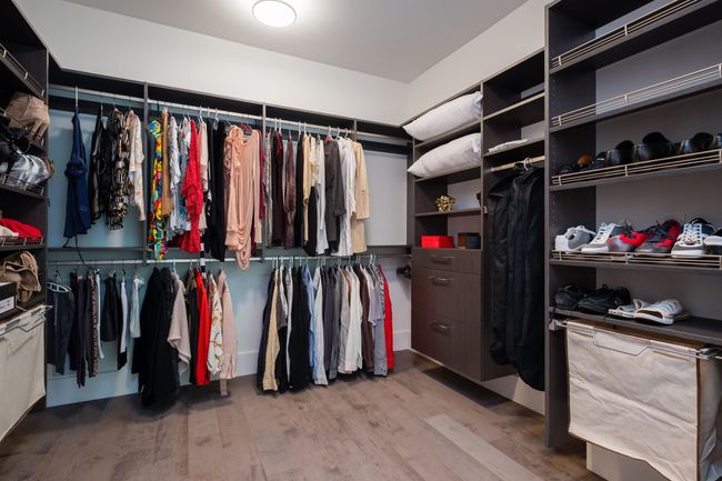 Walk in closet featuring wood finished floors | Image 25