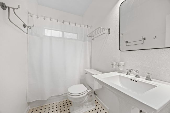 Bathroom with shower / bath combination with curtain and a textured wall | Image 23
