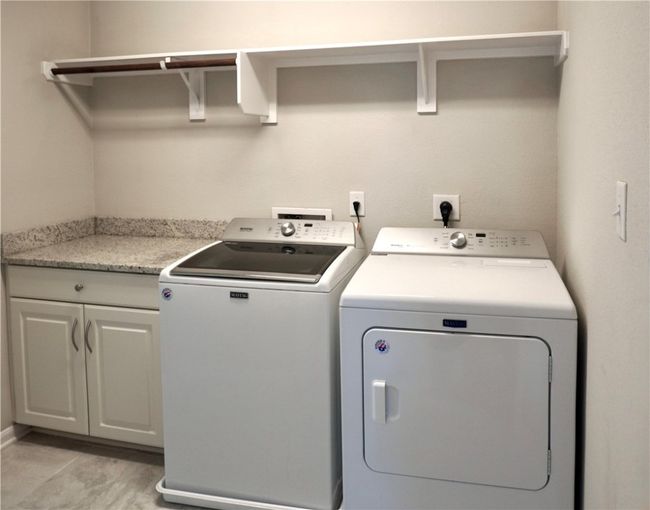 Laundry area with separate washer and dryer and cabinet space | Image 13