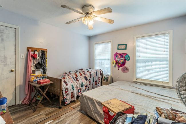 Bedroom featuring wood finished floors and ceiling fan | Image 13