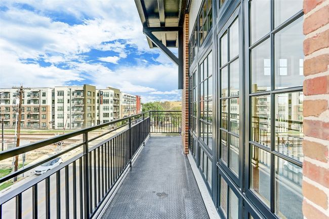 The expansive outdoor balcony provides a private space to enjoy fresh air and take in the views. | Image 7