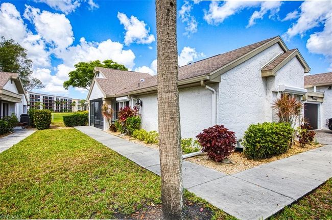 View of side of home with stucco siding and a yard | Image 6
