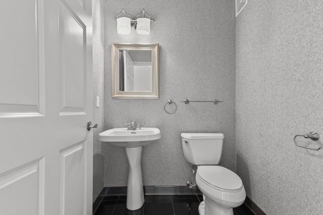 Main level ½ bath with ceramic flooring. | Image 8