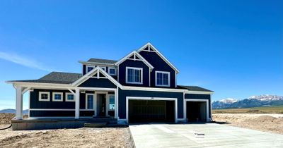 View of front of home featuring a garage, a mountain view, and covered porch | Image 1