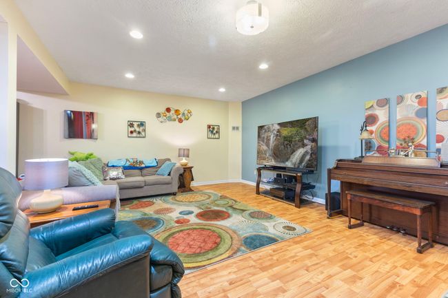 living area featuring wood finished floors, recessed lighting, and a textured ceiling | Image 31