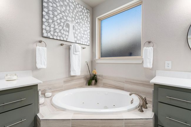 Bathroom featuring vanities and a jetted tub | Image 21