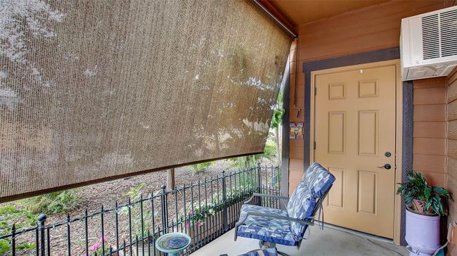 Back Patio offers privacy and comfort. Fenced in for a small dog, pull down shades for the late summer months. Beautiful sunsets. Secure storage closet located off patio. | Image 32