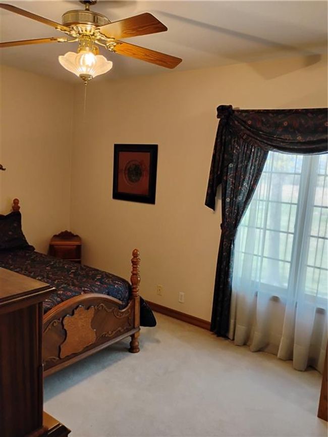 Upstairs Bedroom #1 with Carpeted bedroom with baseboards and ceiling fan | Image 67