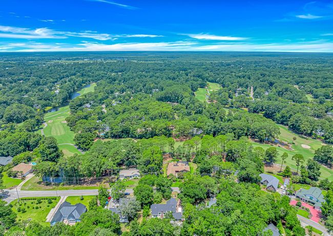 Aerial view of property's location with a local golf course and nearby suburban area | Image 33