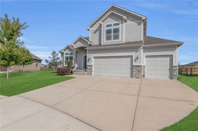 View of front facade with a garage and a front lawn | Image 3