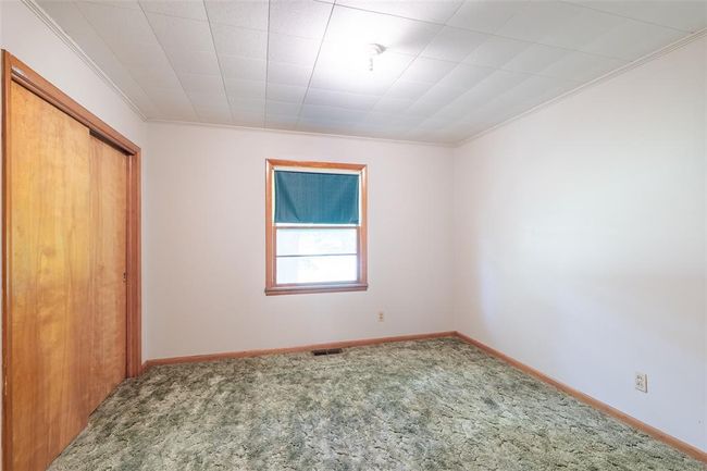 Unfurnished living room with heating unit, wood finished floors, ceiling fan, and baseboards | Image 12