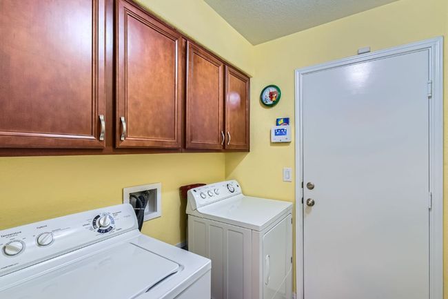 Washroom featuring cabinet space and hookup for a washing machine | Image 20