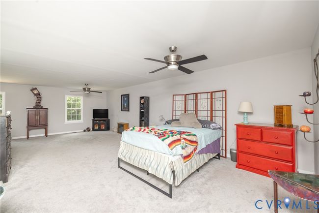 Bedroom with light colored carpet and a ceiling fan | Image 42