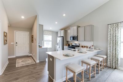 This functional kitchen boasts 42' cabinets with hardware, stainless steel appliances and quartz countertops. Photo is of model home. Colors and options may vary. Ask Sales Agent for details. | Image 2