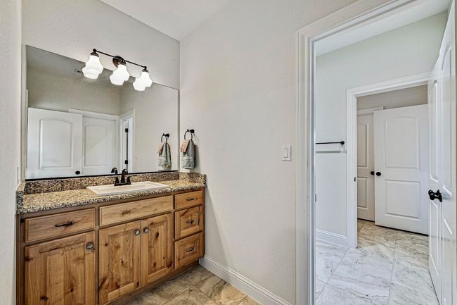 Bathroom featuring vanity and marble finish flooring | Image 23