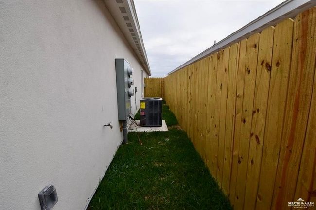 View of side of home featuring stucco siding and a central air condition unit | Image 7