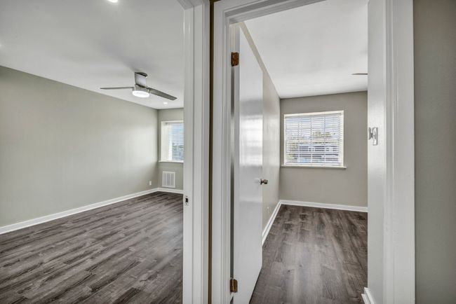 Hallway featuring baseboards and dark wood-style floors | Image 17