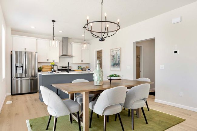 Beautiful, continuous SPC flooring runs through foyer, gathering room, kitchen, dining and mudroom. | Image 7
