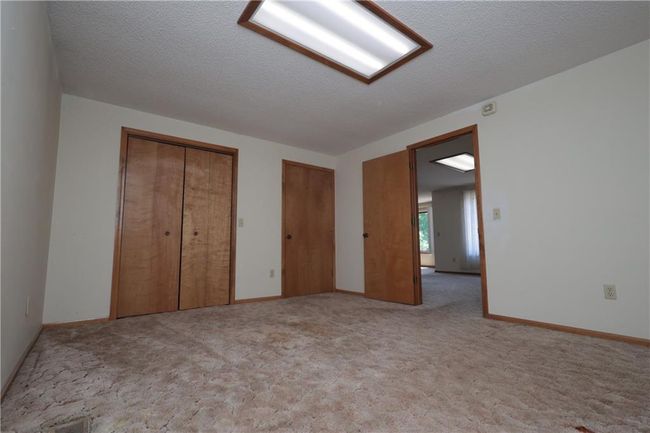 Unfurnished bedroom featuring multiple closets and carpet floors | Image 24