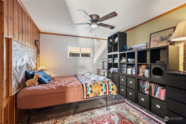 The lower-level bedroom offers a quiet and private retreat, making it an ideal space for accommodating guests. A peaceful location ensures comfort and relaxation | Image 24