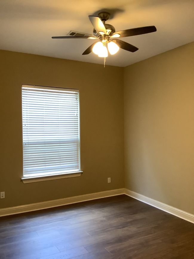 Unfurnished room featuring ceiling fan and dark wood-style flooring | Image 6