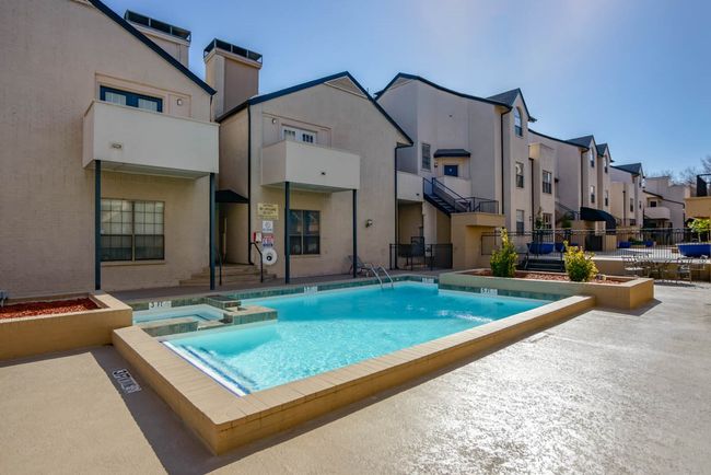 View of swimming pool with a residential view and a pool with connected hot tub | Image 15
