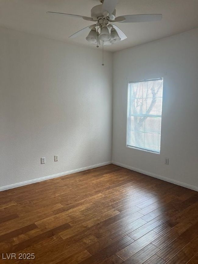 Unfurnished room featuring ceiling fan and dark wood finished floors | Image 15