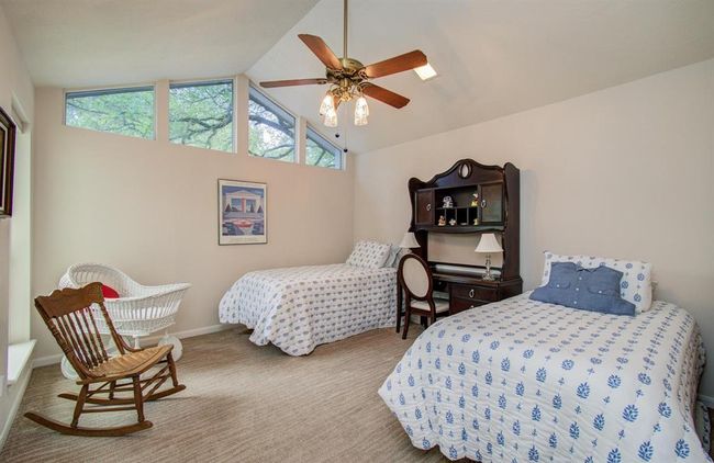 Another one of the secondary bedrooms that enjoys a treetop view with its vaulted ceiling. | Image 30