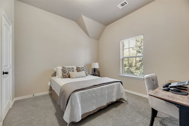 Bedroom with light carpet, vaulted ceiling, and a desk | Image 21