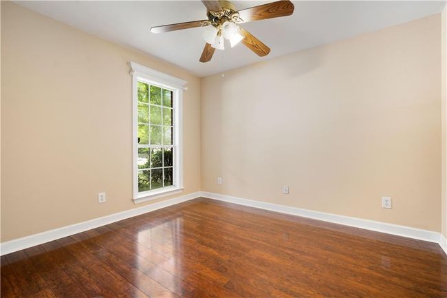 Spare room with dark wood finished floors and a ceiling fan | Image 23