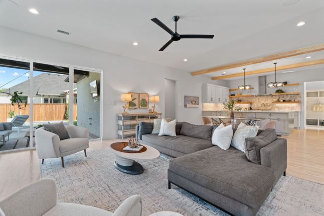 Living room featuring recessed lighting, a ceiling fan, light wood finished floors, and beam ceiling | Image 10
