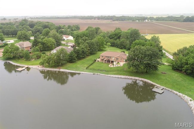 Aerial view of sparsely populated area with a large body of water | Image 6