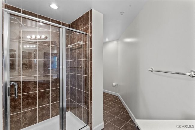Full bath featuring recessed lighting, a shower stall, tile patterned flooring, and baseboards | Image 34