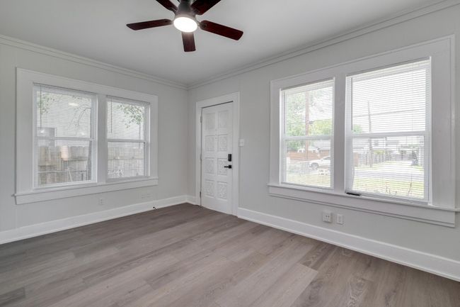 Foyer entrance with healthy amount of natural light, a ceiling fan, wood finished floors, and crown molding | Image 26