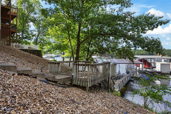 Deck featuring a water view and a boat dock | Image 30