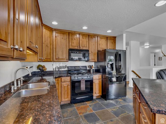 Kitchen featuring knotty alder cabinets, granite countertops, all major appliances included | Image 11