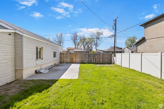 View of yard with a patio area and a fenced backyard | Image 53