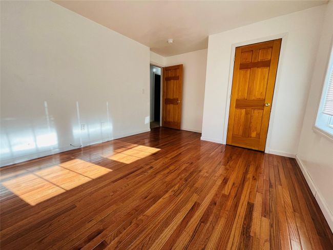 another view 2nd bedroom with hardwood floor | Image 15