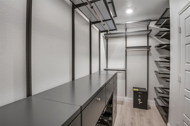 Walk in closet with light wood-style flooring | Image 14