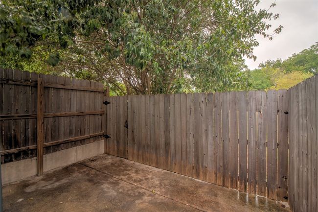 Fenced backyard featuring a gate and a patio area | Image 26