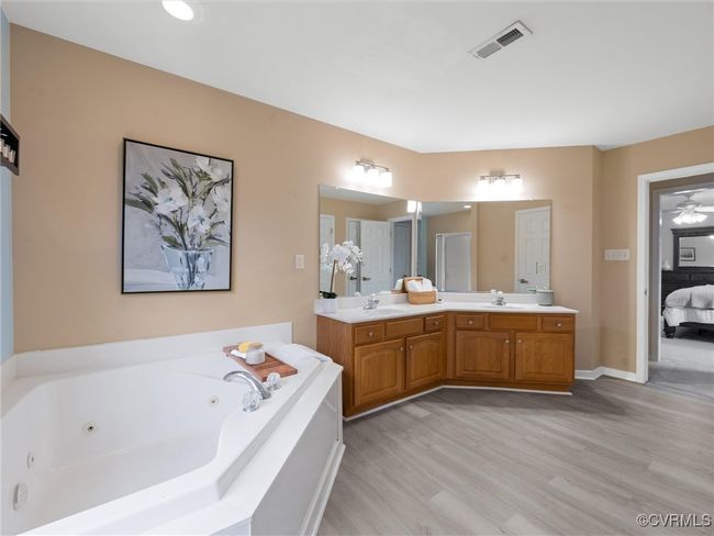 Full bathroom with ensuite bath, double vanity, new floors and garden tub | Image 19