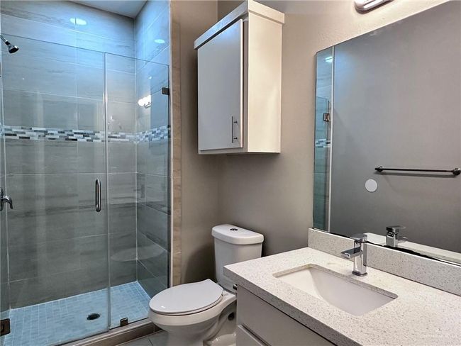 Full bath with a shower stall, toilet, and vanity | Image 15